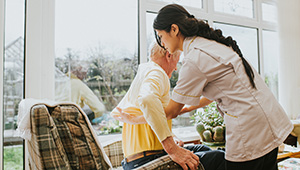 Woman helping elderly woman