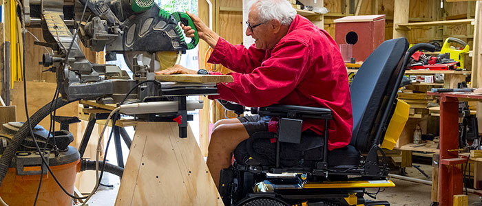 Person with wheelchair at wood shop