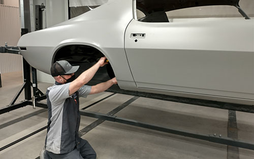 Cale Greig preparing a 1970 Camaro for a new paint job