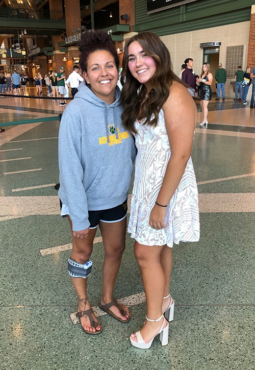 Jazmine Steinfeldt, shown with daughter Jaidyn, is wearing a WalkAide, which has helped her overcome a symptom of multiple sclerosis and continue working.