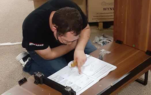 Nikita assembling a fireplace during his first Project SEARCH rotation at Bush & Gilles Furniture